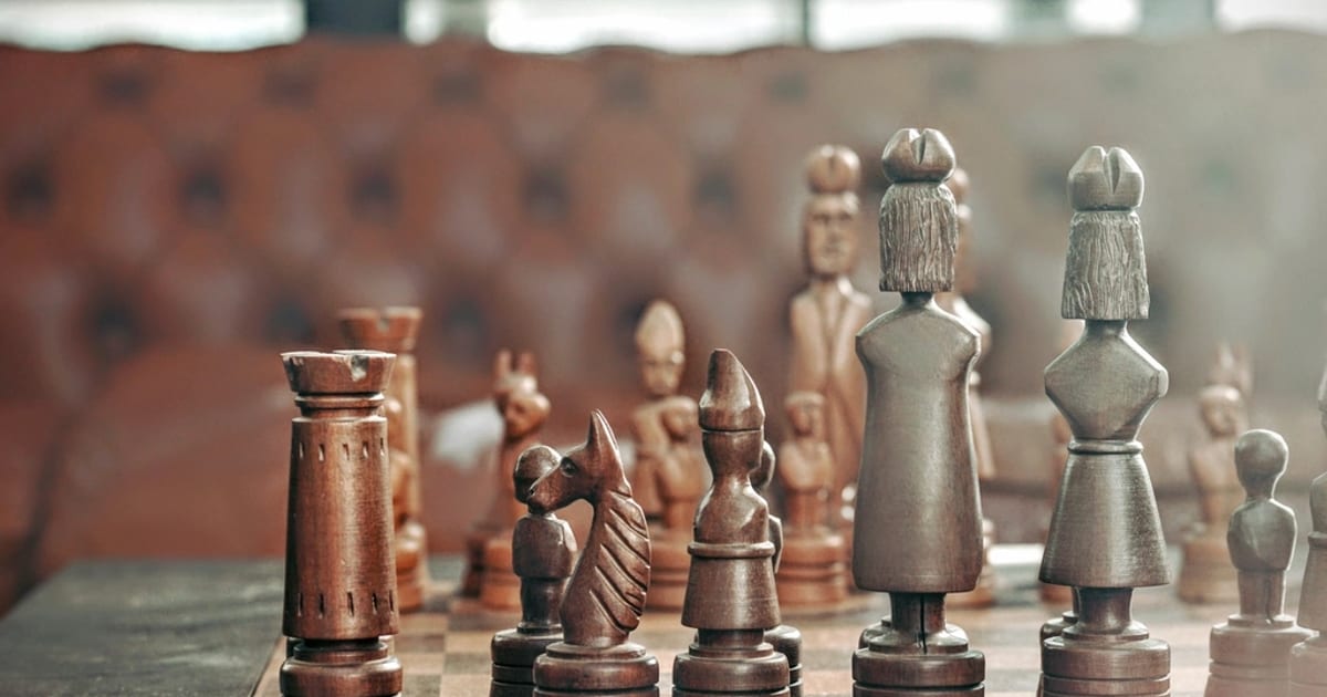 Rows of metal chess pieces lined up on a board